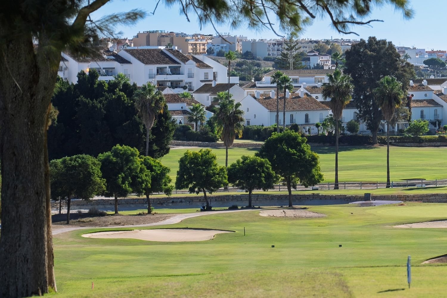 A golf course in Mijas, with white Andalusian houses beyond the fairway.
